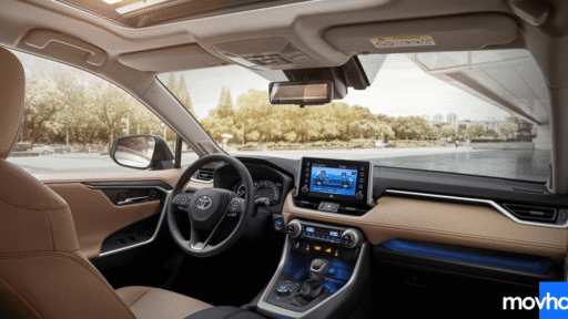 A driver pressing buttons to learn how to reset maintenance light on toyota rav4