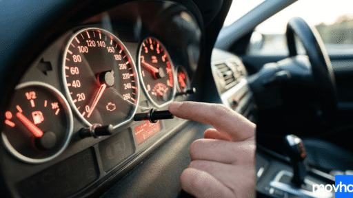 A driver pressing the trip button to learn how to reset maintenance on 2016 toyota corolla